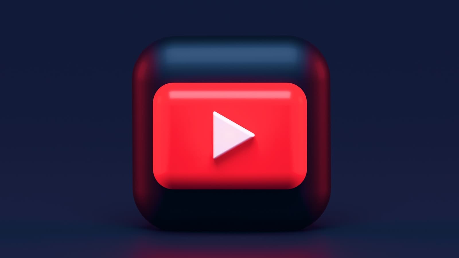 Glossy red YouTube play button icon rendered in three dimensions against a dark background